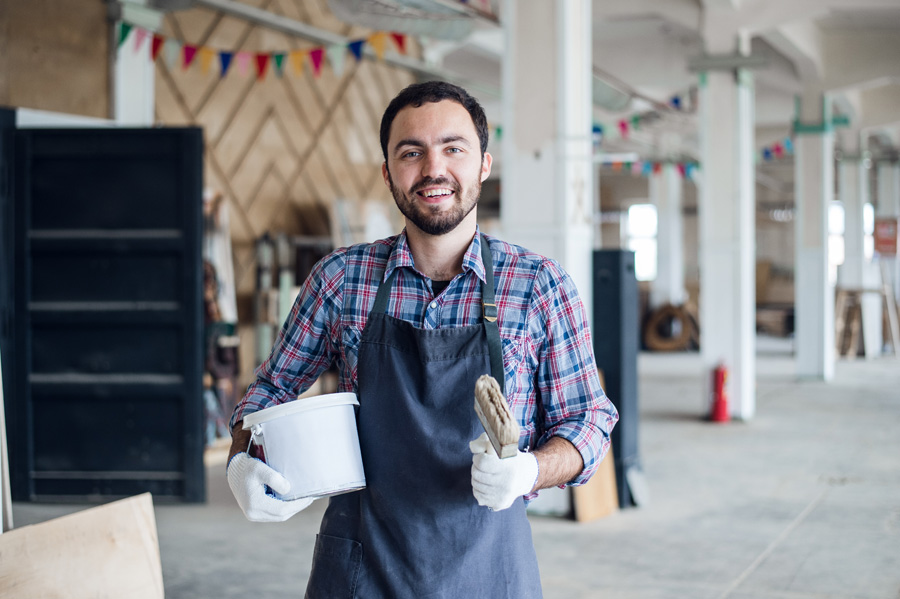 2painter-with-a-can-and-brush-at-his-work-room-PMTQU2C